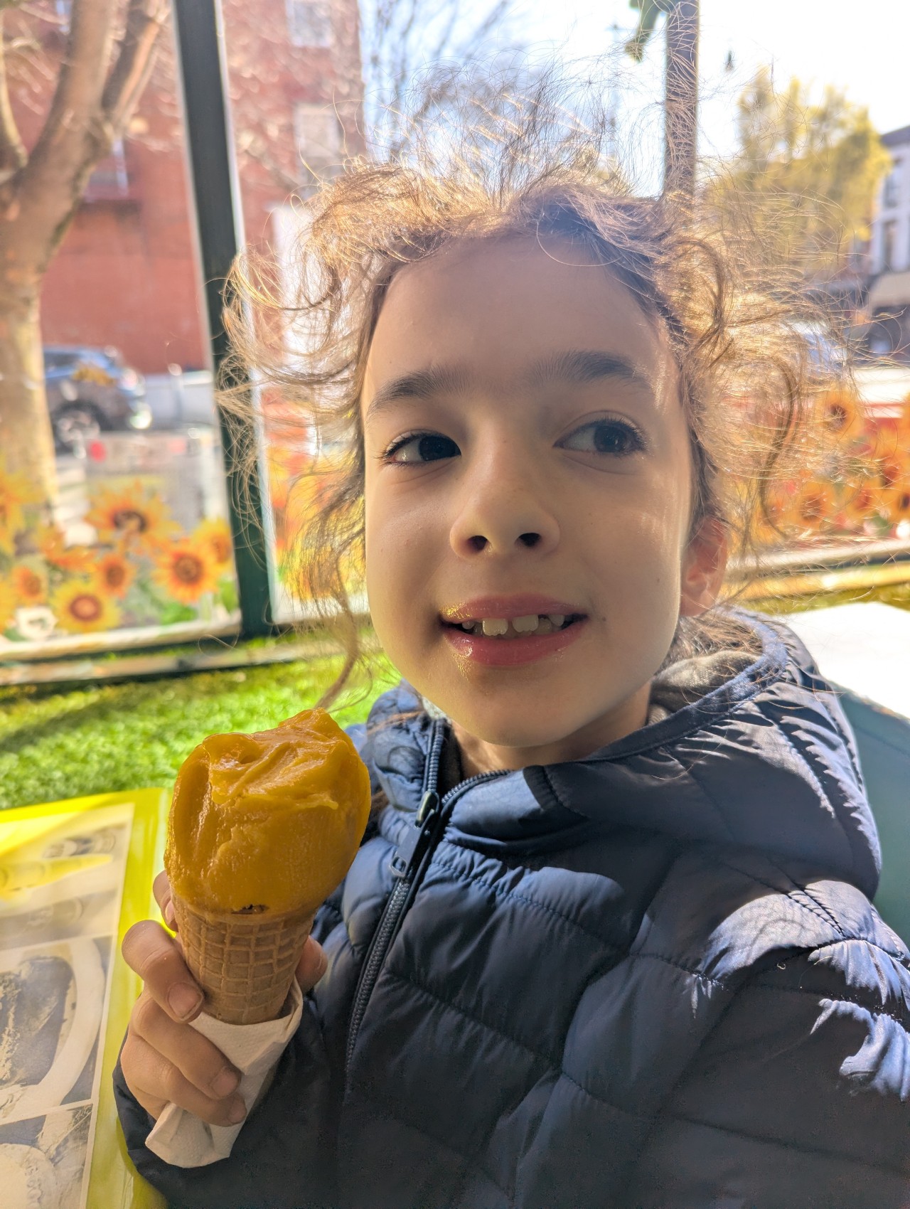 Lucia — holding a mango gelato cone